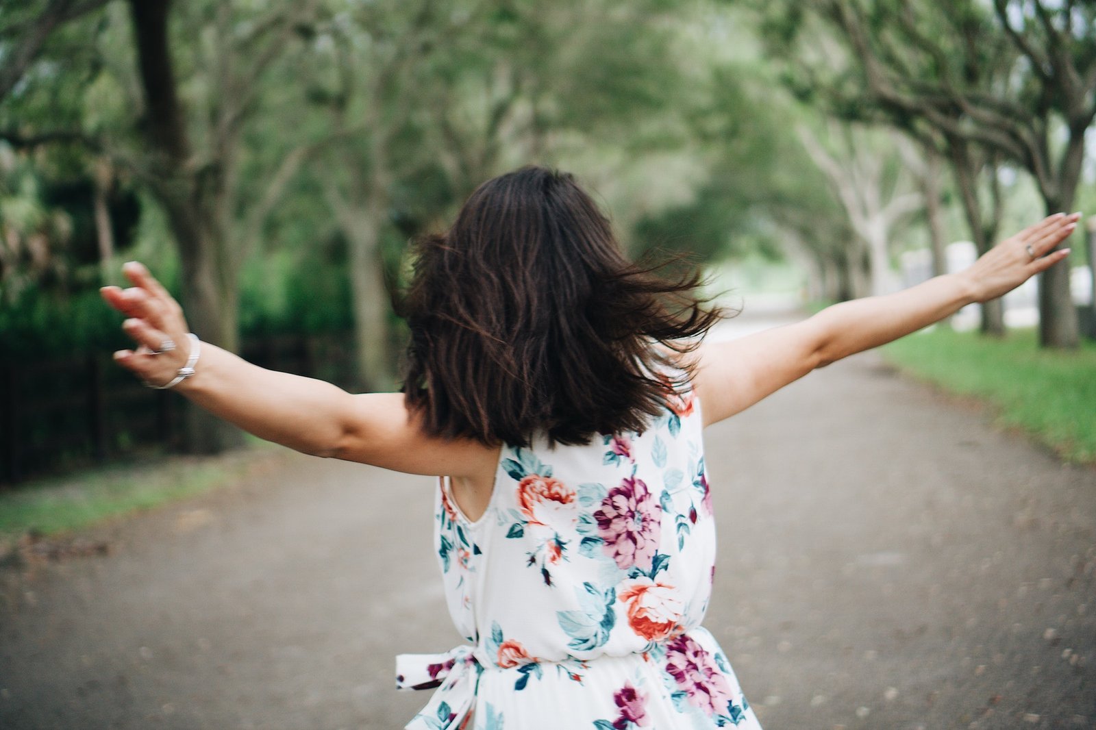 Happy free woman with arms in the air