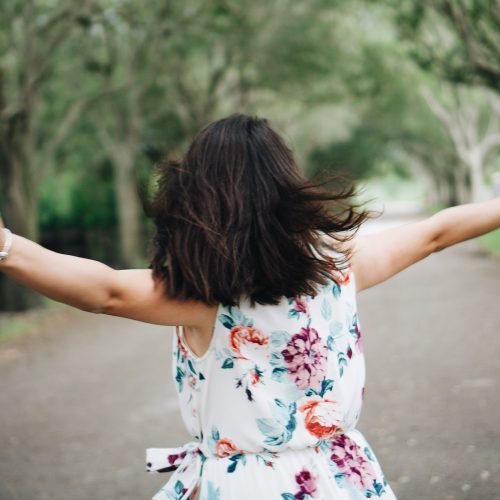 Happy free woman with arms in the air