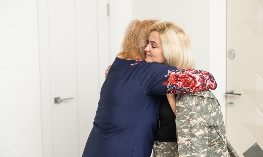 military woman and elderly mother at home